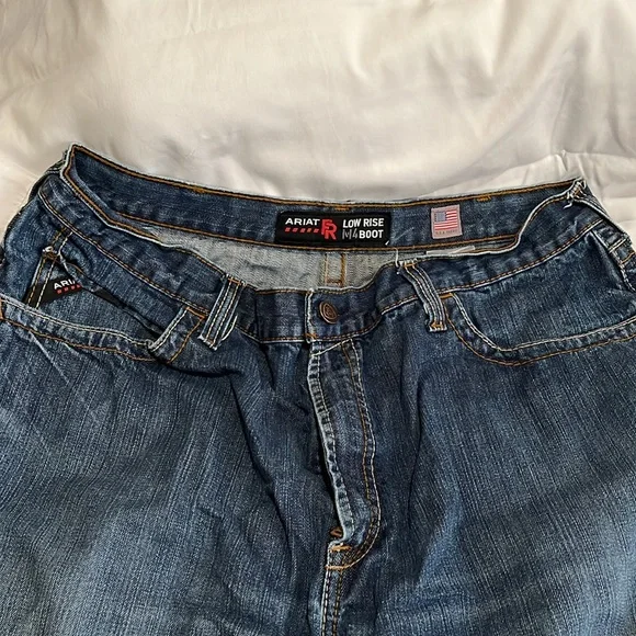 2 pairs of Arita low rise M4 boot jeans that are not hemmed